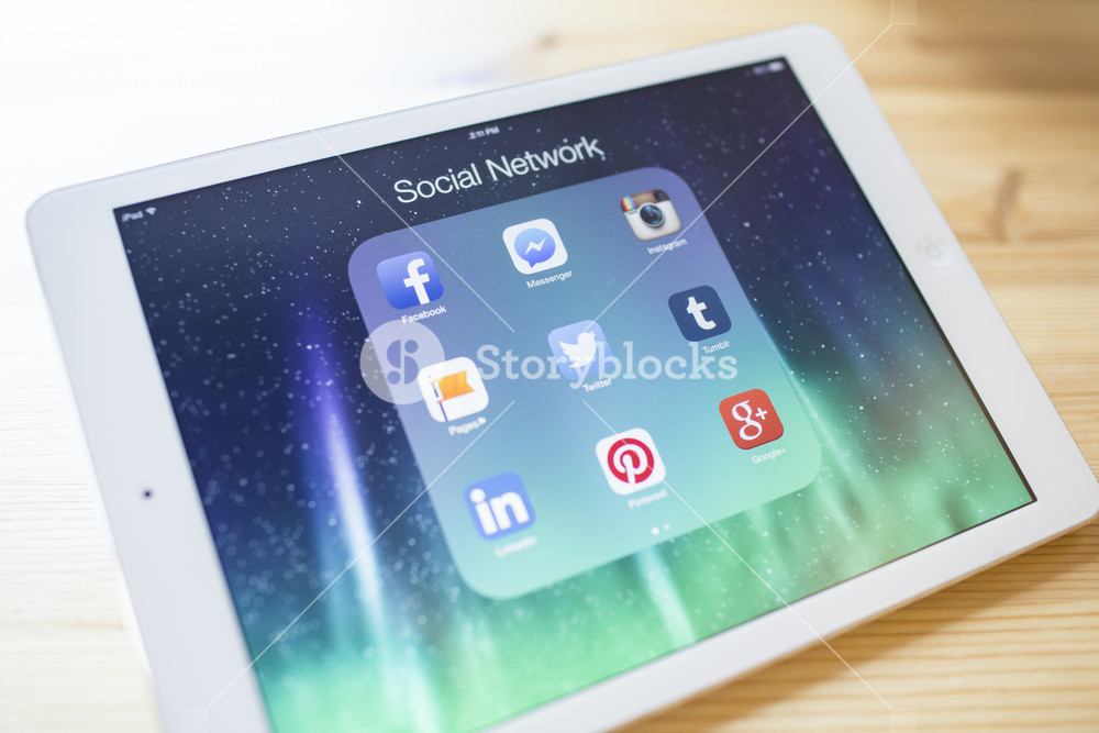 CHIANG MAI, THAILAND - SEPTEMBER 07, 2014: All of popular social media icons on Apple new iPad Air device screen wood background.